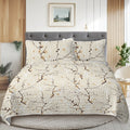 Bed with floral-patterned comforter and pillows in a bedroom setting