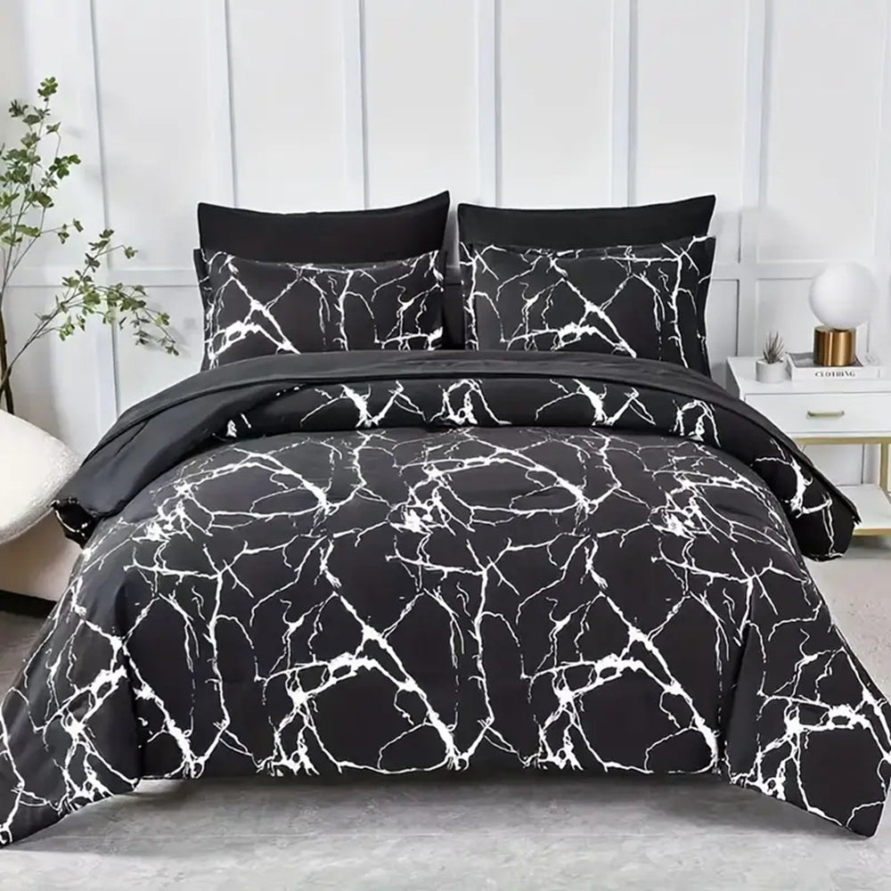 Black and white marble patterned bedding set on a bed with pillows against a white paneled wall.