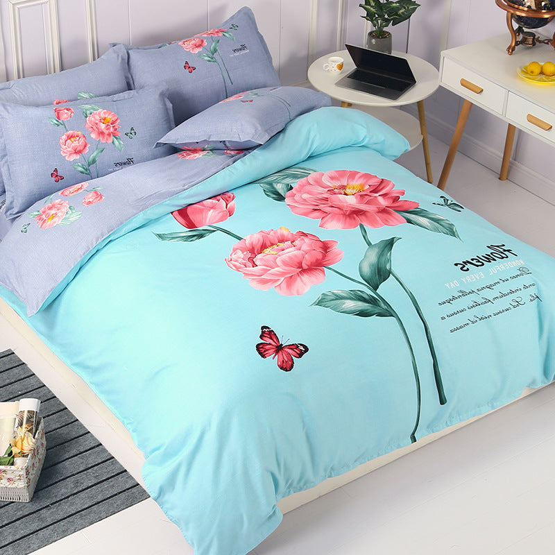 Floral and butterfly design on light blue bedding set in a bedroom.